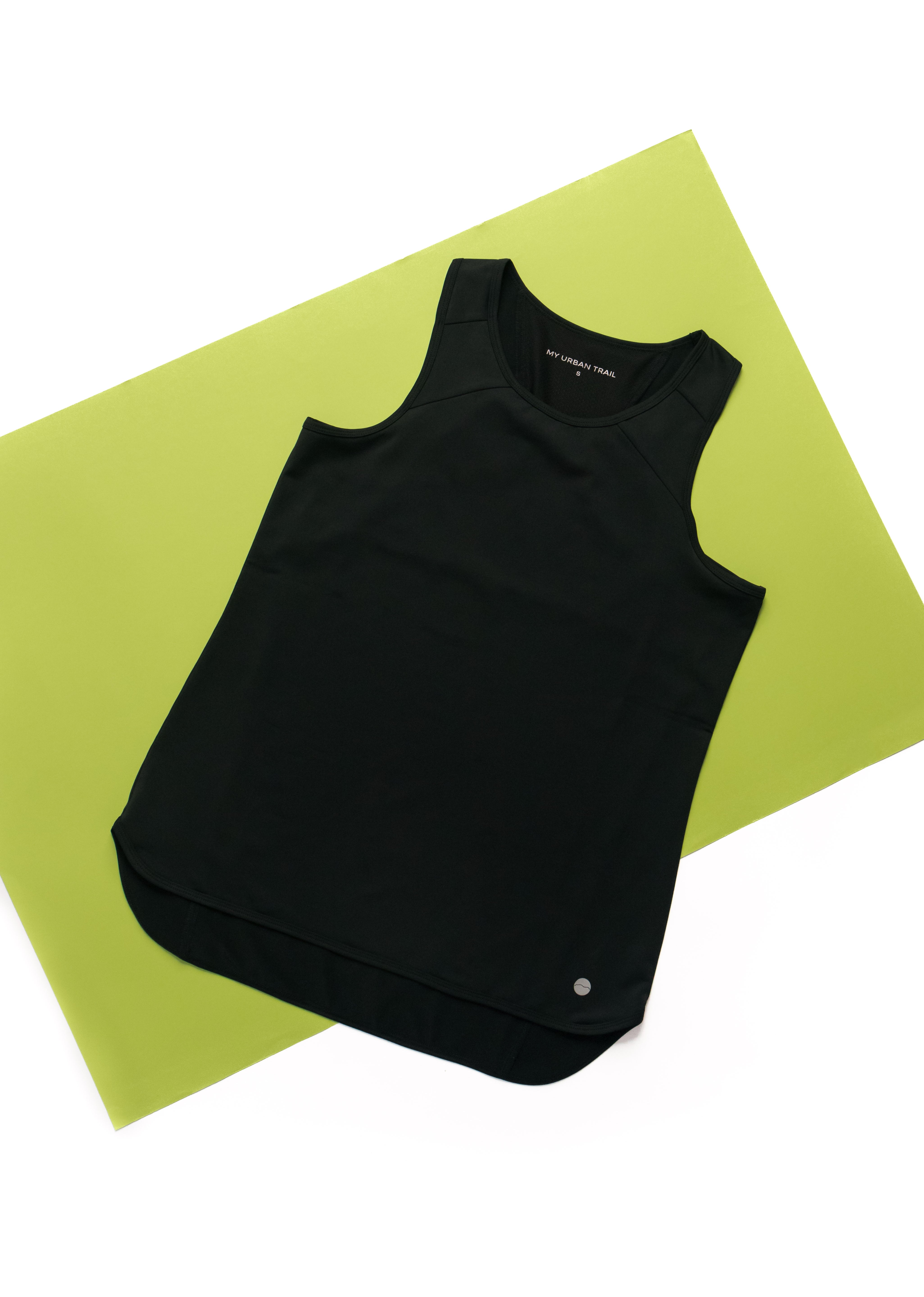 Black sleeveless top on a green mat