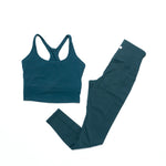 Teal athletic top and leggings set on a white background