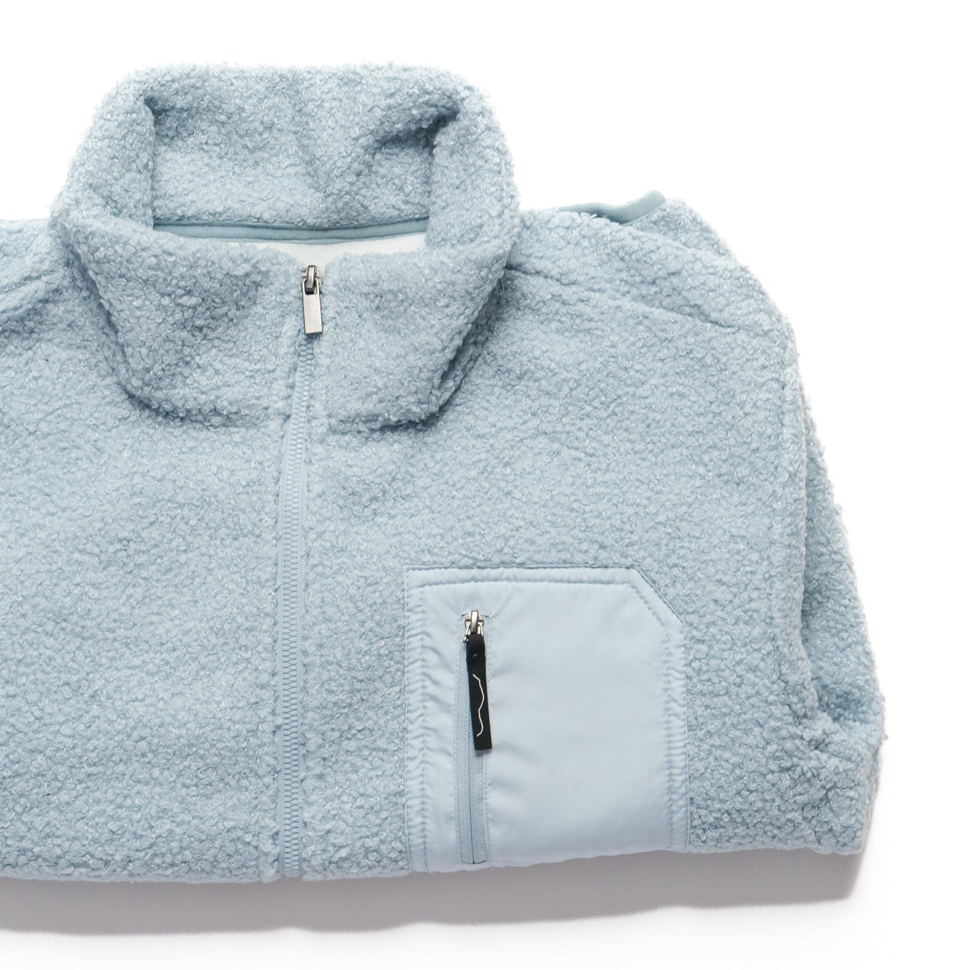 Light blue fleece pullover with a pocket on a white background