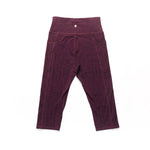 Maroon leggings on a white background