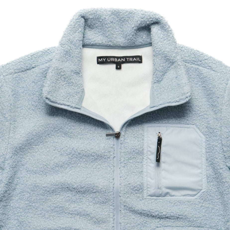 Light blue fleece jacket with a visible brand label on a white background